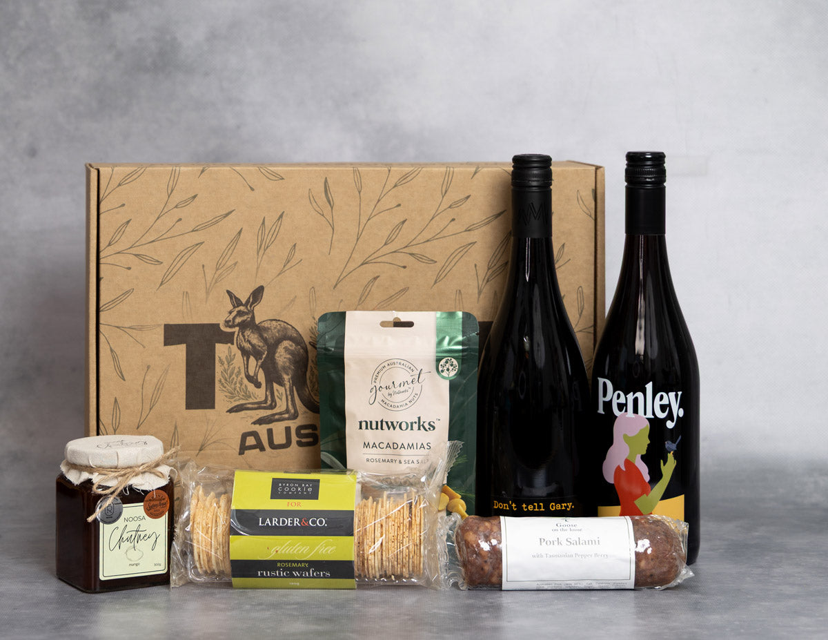 Bold Red Hamper. Gourmet gift set with Penley wine, macadamias, and other snacks on a gray background